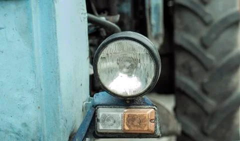 Headlight closeup on the tractor. old rusty green historical vintage tractor Stock Photos