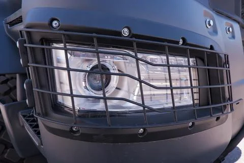 The headlight of a dump truck protected by a grid Stock Photos