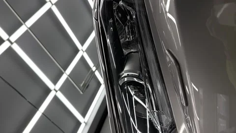 Headlight of Grey mirror premium car in the detaling studio after polishing Stock Footage 243567688