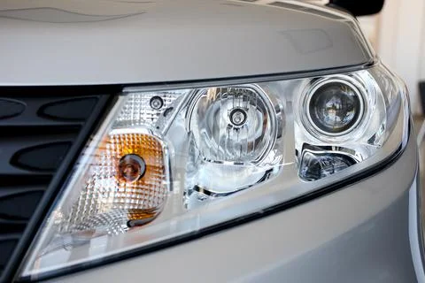 Headlight of a large silver car Stock Photos
