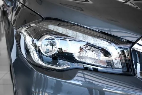 Headlight of a large silver car Stock Photos