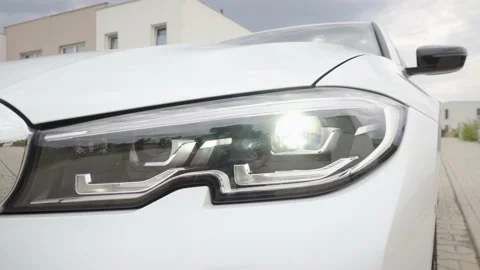 Headlight of a modern car BMW 3 Series in a suburban area - closeup 스톡 동영상 145150107