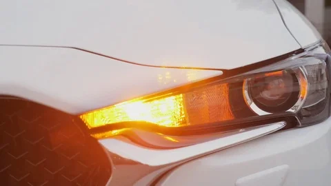 Headlight of modern car flashes Stock Footage 82950864