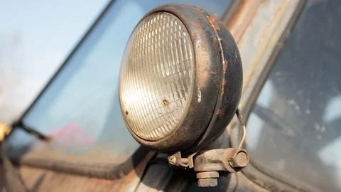 Headlight of a retro car in a rusty condition Stock Photos