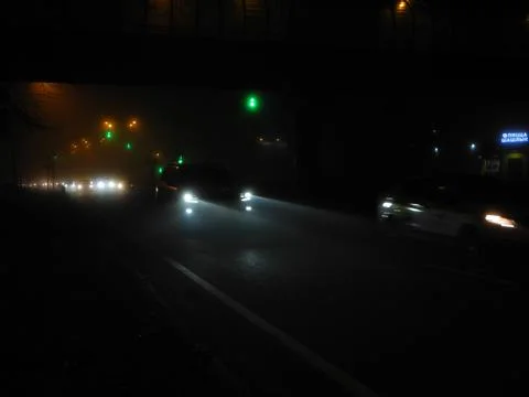 Headlights in the fog Stock Photos