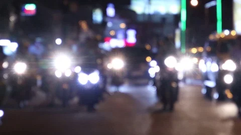Headlights of passing motorcyclists without focus in Vietnam. Vídeos de archivo 119563236