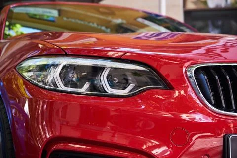 Headlights of red car Stock Photos