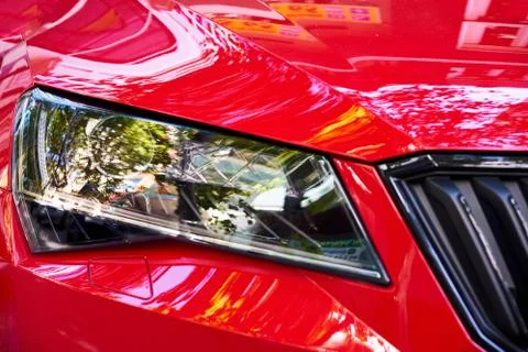 Headlights of red car Stock Photos