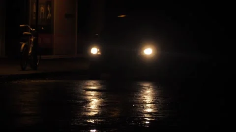 The headlights shine when the car is driving on the road. Stock Footage 219744297