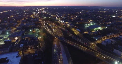 Headlights streaming along a sunken expressway at dusk Stock Footage 63063020