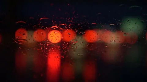 Headlights through the wet window of a car Stock Footage 78603421