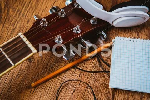 Headphone guitar notebook and pencil Stock Photos