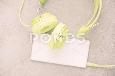 Headphones And Mobile Phone On Table In Close Up