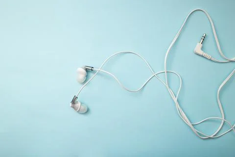 Headphones for gadget on background Stock Photos