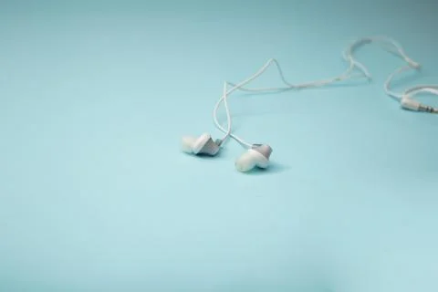 Headphones for gadget on background Stock Photos