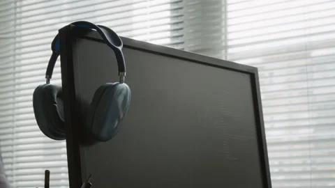 Headphones Hanging off Computer Screen at Software Developer Desk Stock Footage 335936497