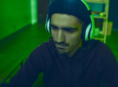 Headphones, man or hacker programming or coding for cybersecurity, online crime Stock-Fotos