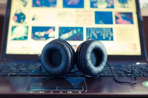 Headphones on notebook Stock Photos