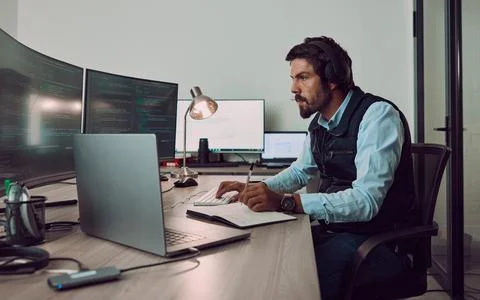 Headphones, programmer and man on computer with book, coding or programming Foto stock