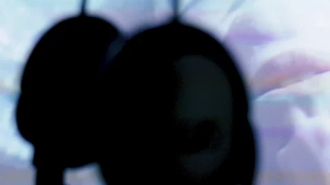 Headphones swinging on screen background Stock Footage 104260324