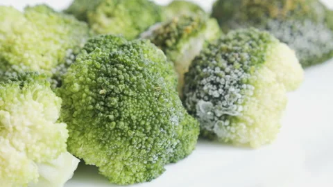 Heads of brocolli on pile 4K pulling focus footage Stock Footage 145496460