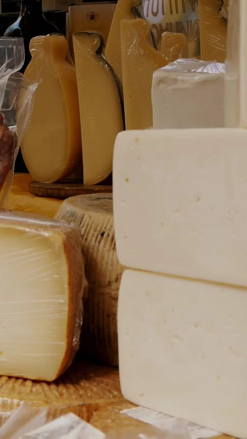 Heads of cheese. different types of homemade hard cheeses. street food. food Stock Footage 317846563