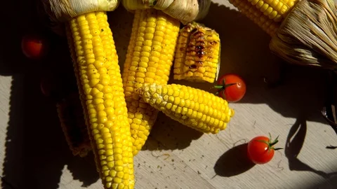 Heads of fried corn are on the table and sprinkled with salt . close up. corn's Stock Footage 91700096
