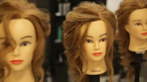 Heads of mannequins with hairstyles in hair academy Stock Footage