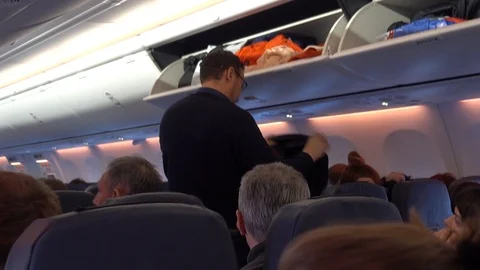 Heads of passengers on the plane. Interior of the salon. Video stock 87913487