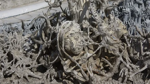 Heads of sinners close-up. White Temple (Wat Rong Khun). Chiang Rai, Thailand Stock Footage 100691756