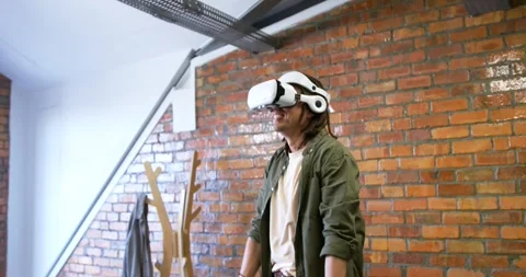 Headset activating, man with white VR headset raising hands, pinching, Stock Footage 341952977