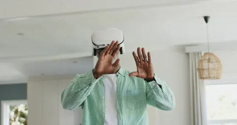 Headset activating, senior man reaching out, pinching, rotating to resize Stock Footage 341943732