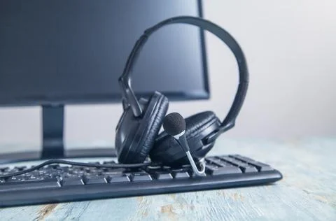 Headset on computer keyboard. Customer service. Support Stock Photos