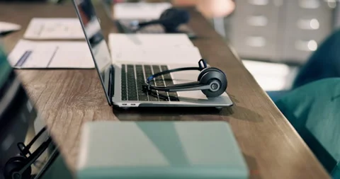Headset, laptop and desk with paper in empty office for customer support Stock Footage 343109232