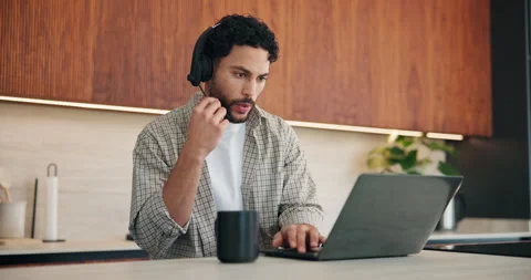Headset, laptop and man in kitchen for remote work, communication and tech Stock Footage 335111097