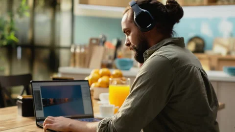 Headset laptop, game developer, building video game, listening to music Stock Footage 330441071