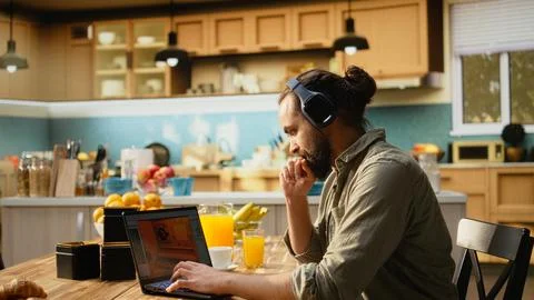 Headset laptop, game developer, building video game, listening to music 스톡 사진
