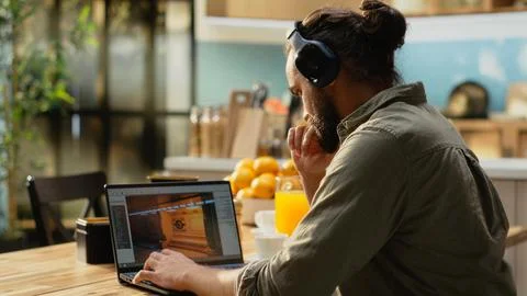 Headset laptop, game developer, building video game, listening to music Stock Photos