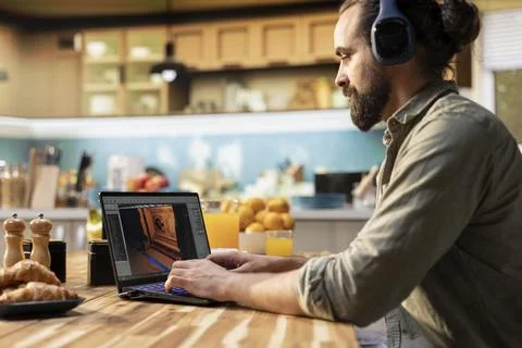 Headset laptop, game developer, building video game, listening to music 스톡 사진