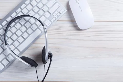 Headset on a laptop keyboard. Stock Photos