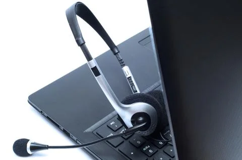 Headset lying on a laptop computer keyboard Fotos Stock