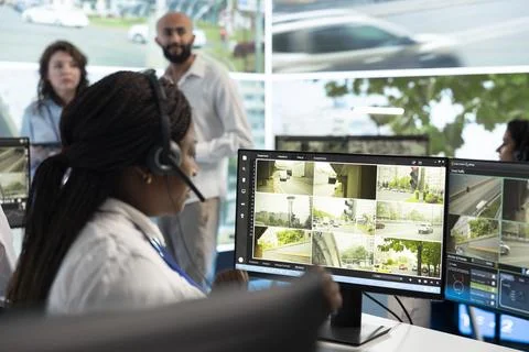 Headset operator reviewing grid of road camera feeds, close up Stock Photos