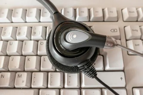 Headset for phone on the computer keyboard both dirty Stock Photos