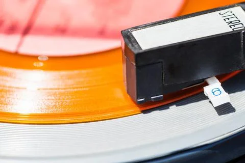 Headshell of record-player on orange vinyl disc headshell of record-player... Stock Photos