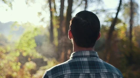 Headshot of Man Observing Forest During Morning Sunrise (Medium Steadicam Orbit) Stock Footage 81492018