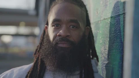 Headshot Portrait of Fit Man with Dreadlocks and Beard Outside at Sunset Stock Footage 270397358