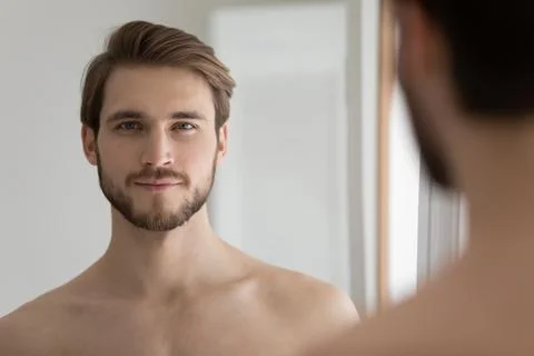 Headshot portrait young handsome shirtless man smile looks at camera Stock Photos