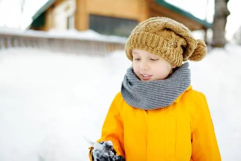 Headshot of preteen boy having fun playing with icicle on winter day. Stock Photos