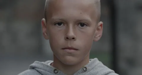 Headshot of serious young boy looking to camera while standing outdoors Stock Footage 144603961