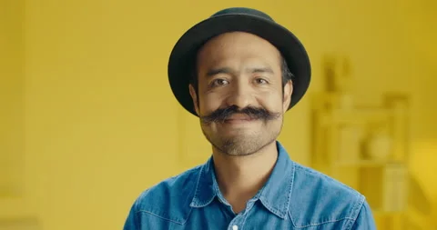 Headshot of young handsome Hispanic man with a mustache looking at camera and Stock Footage 171446756